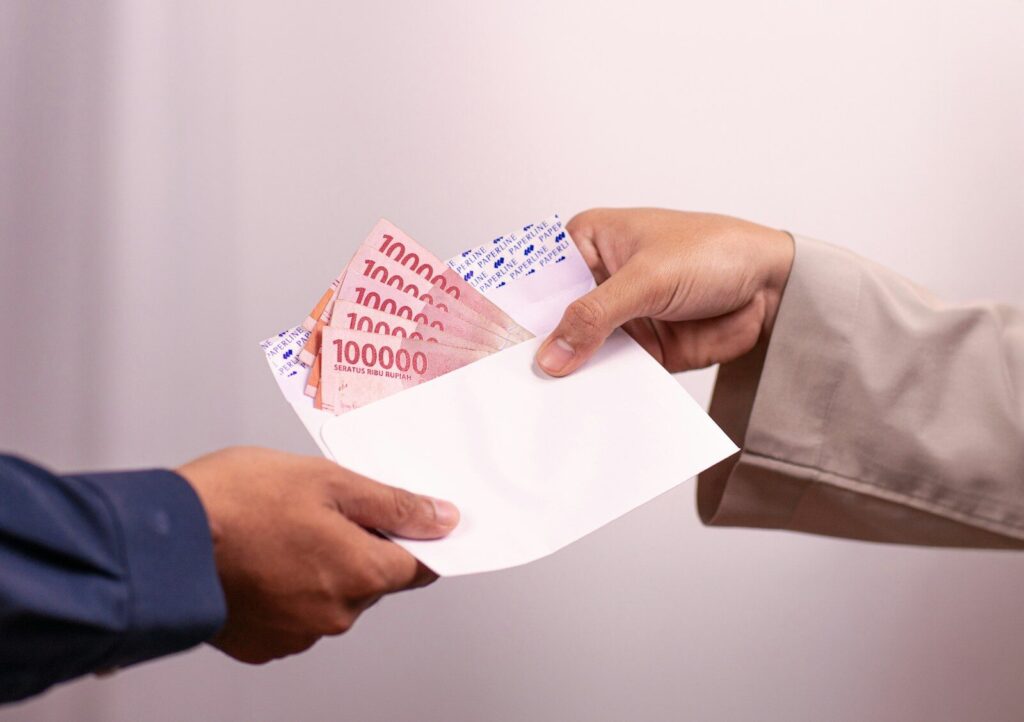 Money is being handed over between two people.